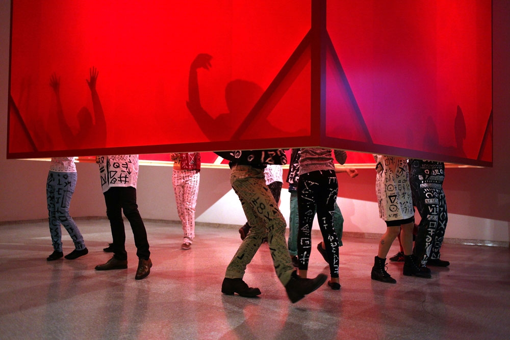 Shuji Mukai performing in Tsuruko Yamazaki&rsquo;s&nbsp;Work (Red Cube)&nbsp;(1956/2013) at the opening&nbsp;of&nbsp;Gutai: Splendid Playground, Solomon R. Guggenheim Museum, New York